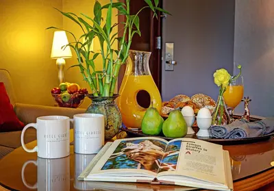 a table with an open book on a table with mugs at Hotel Giraffe by Library Hotel Collection in New York