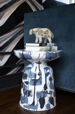 a cat statue sitting on top of a plate with books at The Renwick in New York