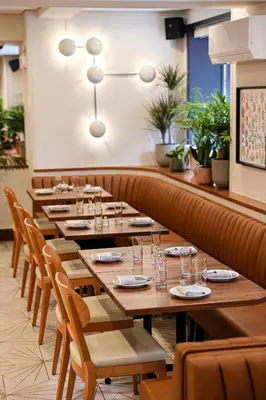 a row of tables and chairs in a restaurant at The Shelburne Sonesta New York in New York