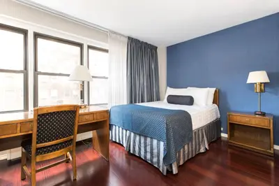 a hotel room with a bed and a desk and window at Murray Hill East Suites - Extended Stay in New York