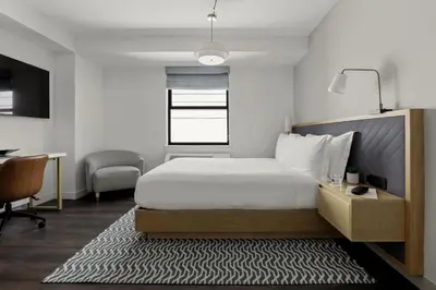 a bedroom with a bed and a desk and a chair at Newly Renovated Rooms at Club Quarters Hotel Times Square, New York in New York