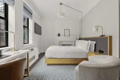 a bedroom with a bed and a desk and a chair at Newly Renovated Rooms at Club Quarters Hotel Times Square, New York in New York