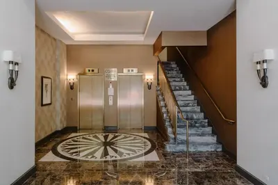 a lobby with a spiral staircase and a stair case at Club Quarters Hotel Rittenhouse Square, Philadelphia in Philadelphia
