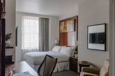 a hotel room with a bed and a television at Club Quarters Hotel Rittenhouse Square, Philadelphia in Philadelphia