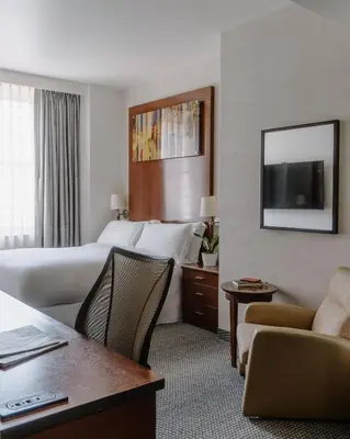 a hotel room with a bed and a tv at Club Quarters Hotel Rittenhouse Square, Philadelphia in Philadelphia