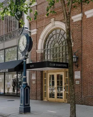 a clock on a pole in front of a building at Club Quarters Hotel Rittenhouse Square, Philadelphia in Philadelphia