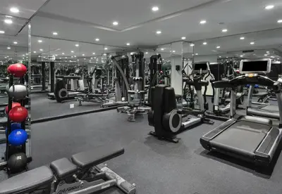 a gym with several treadmills and other equipment at The Time New York, part of JdV by Hyatt in New York