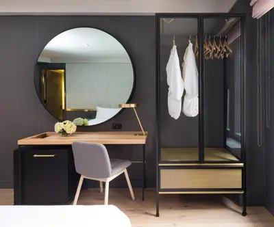 a bedroom with a desk and a mirror and a chair at The Time New York, part of JdV by Hyatt in New York