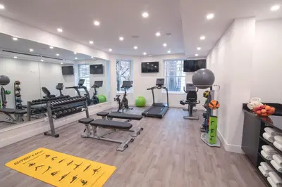 a gym with treadmills and exercise equipment in a room at Hotel Belleclaire Central Park in New York