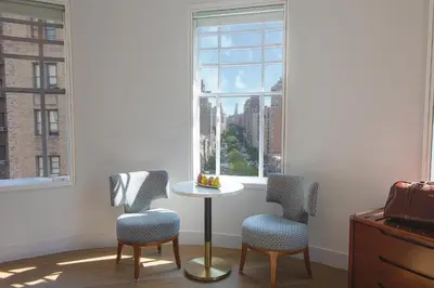 a room with two chairs and a table and a window at Hotel Belleclaire Central Park in New York