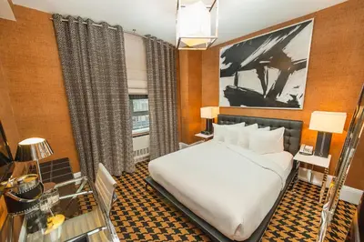 a hotel room with a bed and a window at Ameritania at Times Square in New York