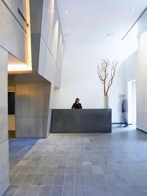 a person sitting on a bench in a room at AKA Central Park in New York