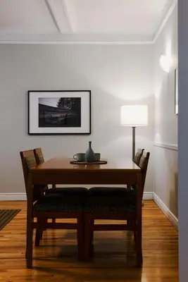 a dining room table with chairs and a lamp at The Bayard in New York