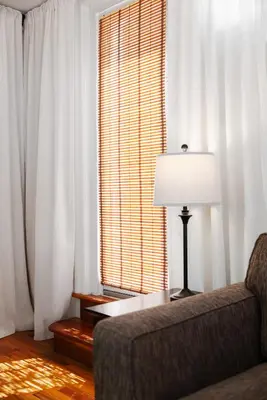 a living room with a couch and a window at The Bayard in New York