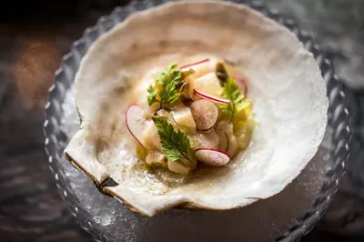 a bowl filled with a tortilla with vegetables in it at The Evelyn NoMad in New York