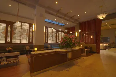 a lobby with a reception desk in a building at The Evelyn NoMad in New York
