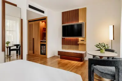 a hotel room with a bed and a tv and a table at Bryant Park Hotel in New York