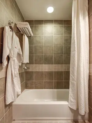 a bathroom with a white tub and a shower at Library Hotel by Library Hotel Collection in New York