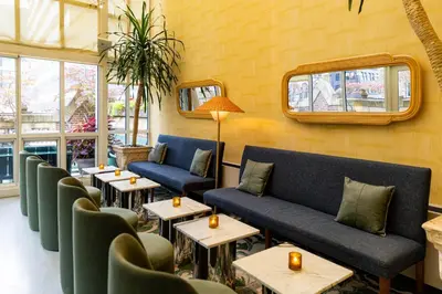 a restaurant with couches and tables and windows at Library Hotel by Library Hotel Collection in New York
