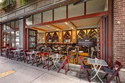 a restaurant with tables and chairs and a piano at Library Hotel by Library Hotel Collection in New York
