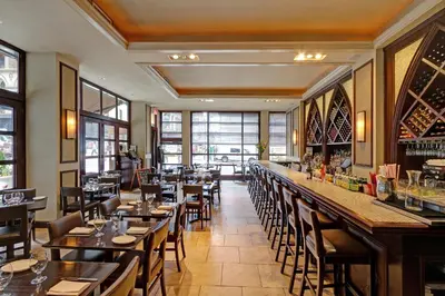 a restaurant with tables and chairs and a bar at Library Hotel by Library Hotel Collection in New York