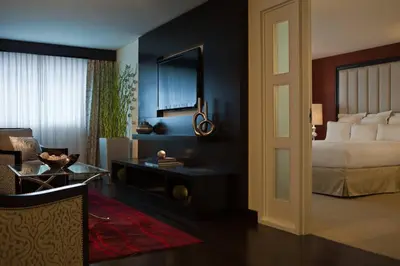 a bedroom with a bed and a table and a room at Renaissance Newark Airport Hotel in Elizabeth
