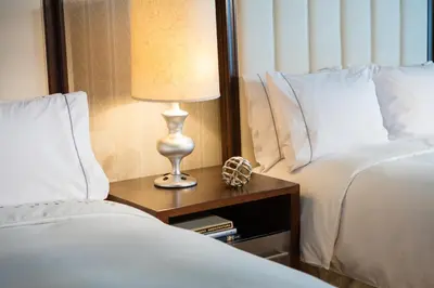 a lamp on a night stand next to two beds at Renaissance Newark Airport Hotel in Elizabeth