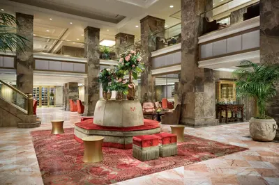 a lobby with a large fountain with flowers in it at The Michelangelo New York in New York