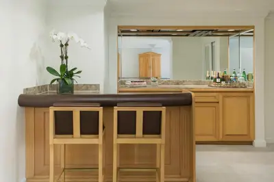 a bathroom with a bar with a mirror at The Michelangelo New York in New York