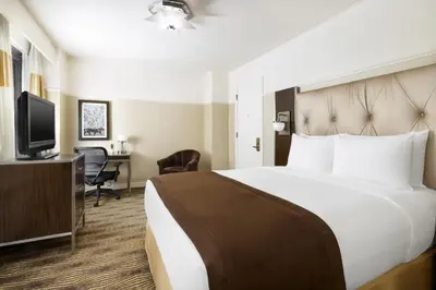 a hotel room with a bed and a desk at New Yorker by Lotte Hotels in New York