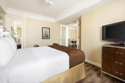 a hotel room with a bed and a flat screen tv at New Yorker by Lotte Hotels in New York