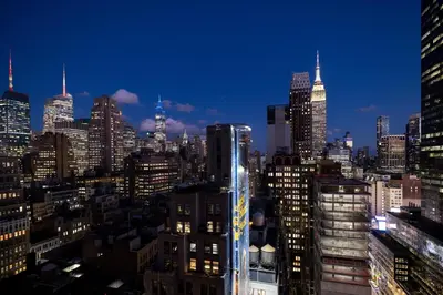 a view of a city skyline at night at New Yorker by Lotte Hotels in New York