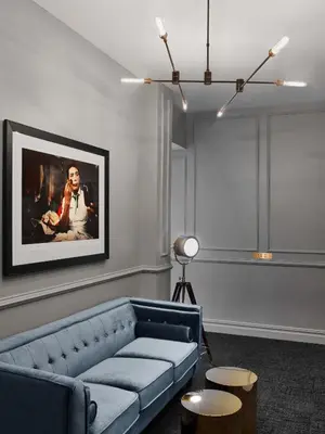 a living room with a blue couch and a painting at Life Hotel New York in New York