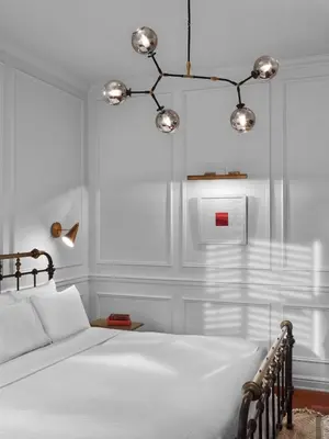 a bedroom with a white bed and a chandelier at Life Hotel New York in New York