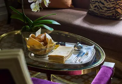 a table with a bowl of bread and a plate of food at 5th & 55th Residence Club in New York