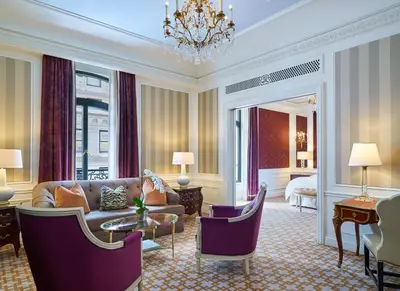 a living room with a couch and a chandelier at 5th & 55th Residence Club in New York