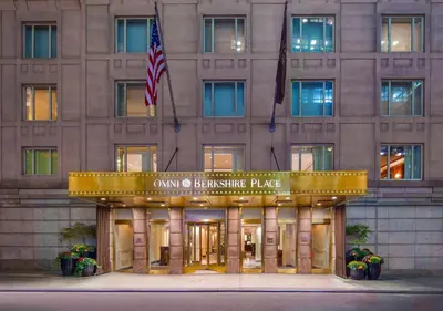 a building with an american flag in front of it at Omni Berkshire Place in New York