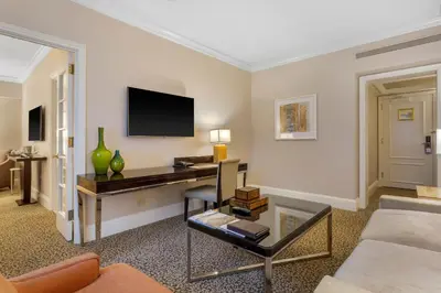 a living room with a tv on a wall at Omni Berkshire Place in New York
