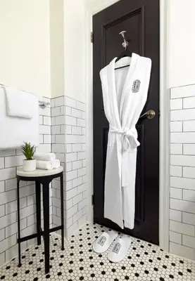 a bathroom with a white towel hanging on a door at The Gregorian New York City in New York