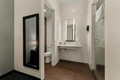 a bathroom with a sink and a toilet and a mirror at Quality Inn Philadelphia Center City in Philadelphia