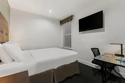 a hotel room with a bed and a desk at Quality Inn Philadelphia Center City in Philadelphia