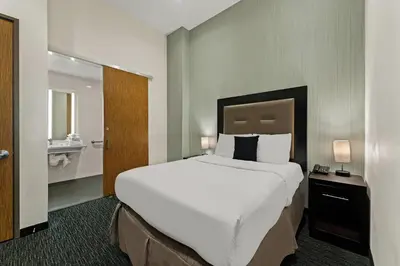 a hotel room with a large bed and a bathroom at Quality Inn Philadelphia Center City in Philadelphia