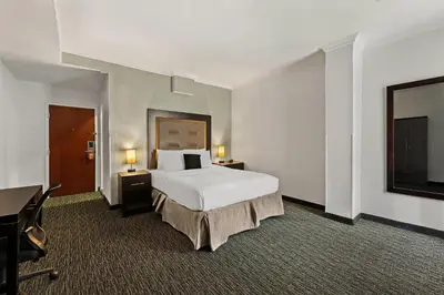 a large hotel room with a bed and a desk at Quality Inn Philadelphia Center City in Philadelphia