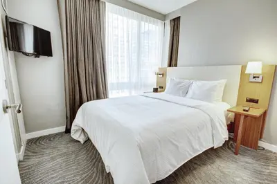 a hotel room with a bed and a large window at Club Wyndham Midtown 45 in New York