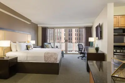 a hotel room with a bed and a kitchen at The Windsor Suites in Philadelphia