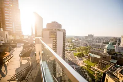 a view of a city from the balcony of a building at The Windsor Suites in Philadelphia