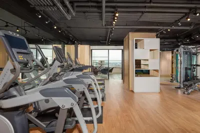 a gym with treadmills and machines in a room at The Windsor Suites in Philadelphia