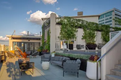 a rooftop patio with furniture and ivy on a building at The Windsor Suites in Philadelphia