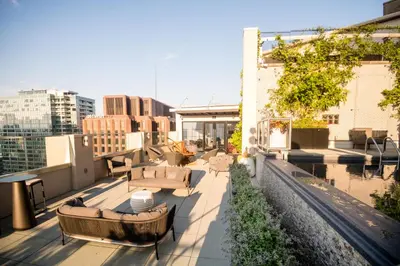 a rooftop patio with couches and tables on a building at The Windsor Suites in Philadelphia