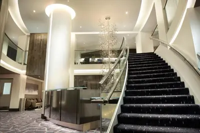 a spiral staircase in a building with a christmas tree at The Windsor Suites in Philadelphia